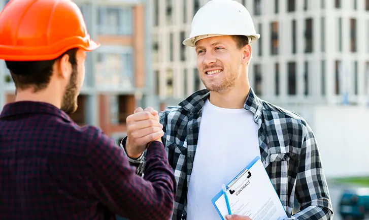 Construction workers handshake